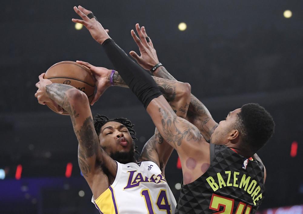 Los Angeles Lakers’ forward Brandon Ingram shoots as Atlanta Hawks’ guard Kent Bazemore defends during their NBA game in Los Angeles Sunday. — AP