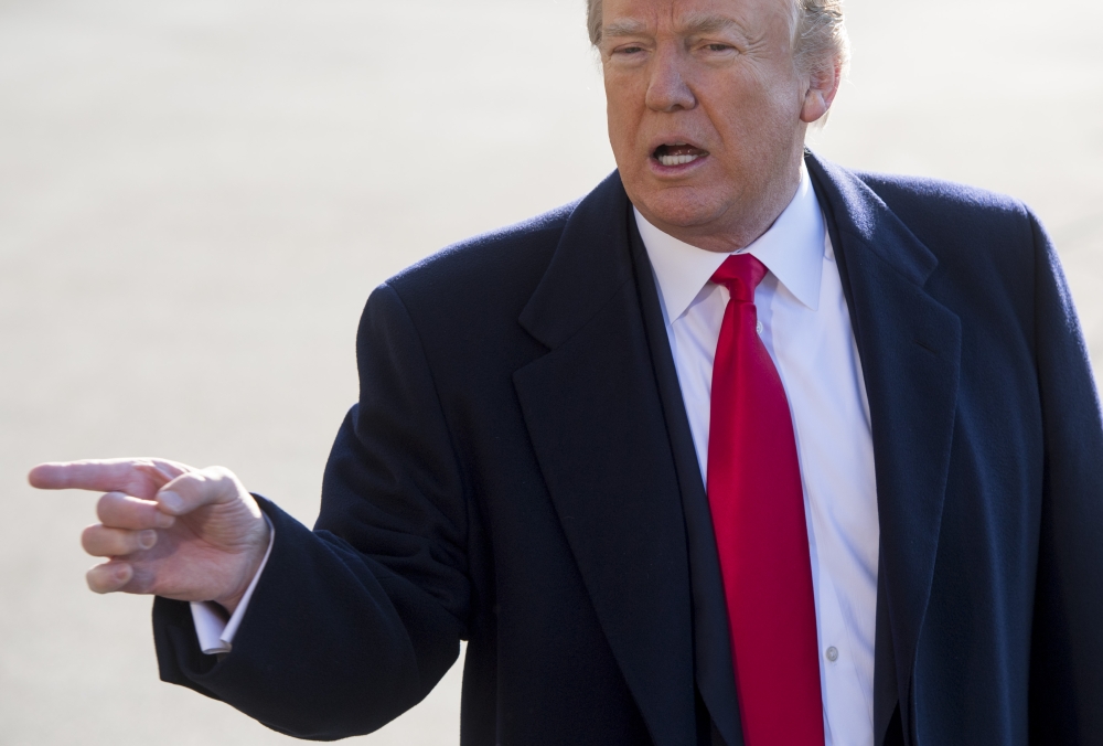US President Donald Trump speaks to the media prior to departing on Marine One from the South Lawn of the White House in Washington on Tuesday. — AFP