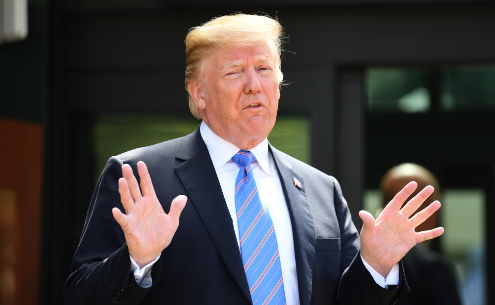 US President Donald J. Trump speaks to media as he departs the G7 summit in Charlevoix in Canada on Saturday. — EPA