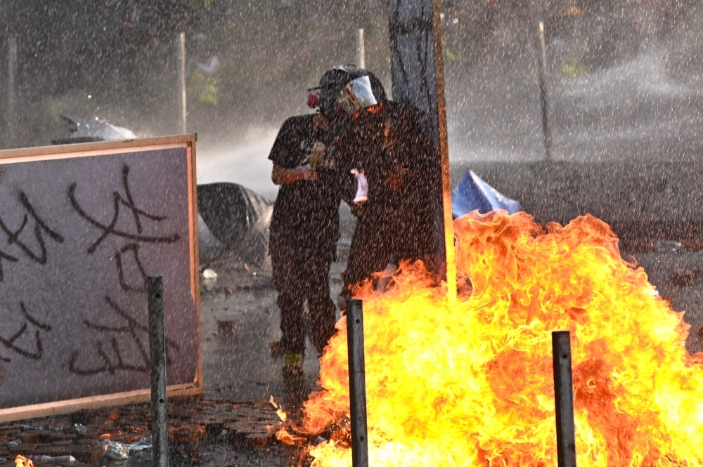 Protesters torch bridges in Hong Kong