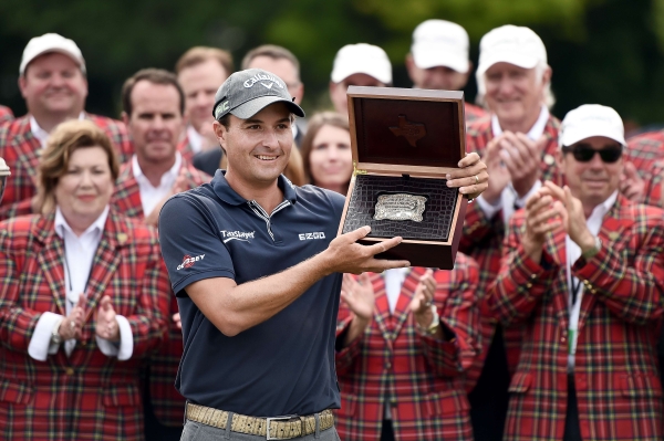 Kevin Kisner accepts a custom made belt buckle after winning the Dean & Deluca Invitational on Sunday in Fort Worth, Texas. — AFP