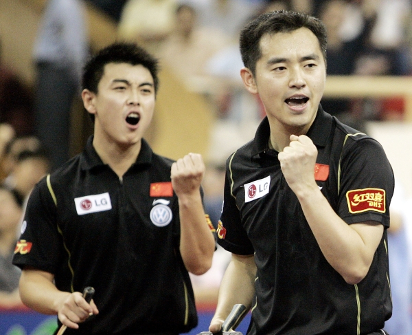 This file photo shows Kong Linghui, right, and Wang Hao, left, of China as they celebrate after winning a point during the men's doubles final match against Timo Boll and Christian Suss of Germany at the 48th World Table Tennis Championship in Shanghai, China. Chinese table tennis great Linghui, was suspended as the national women’s team coach on Tuesday in the wake of a lawsuit over his alleged casino debts. — AP