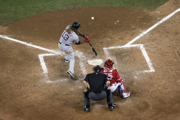 Boston Red Sox designated hitter Hanley Ramirez (13) hits a two-run home run off Toronto Blue Jays relief pitcher Jeff Beliveau as catcher Russell Martin, right, looks on during seventh-inning baseball game action in Toronto, Sunday. — AP
