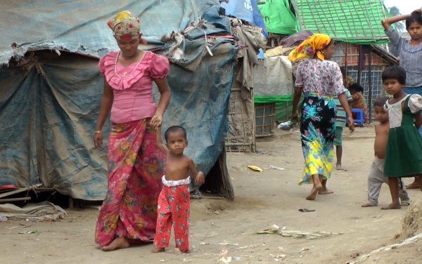 Rosmaida Bibi, second from left, who suffers from severe malnutrition walks with the help of her mother Hamida Begum at the Dar Paing camp, north of Sittwe, Rakhine State, Myanmar. - AP