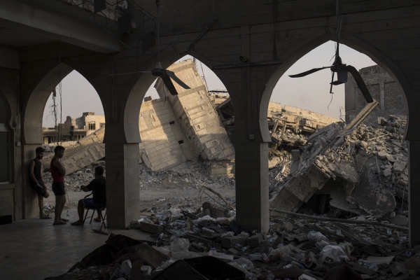 Iraqi federal policemen stand in a damaged building as Iraqi forces continue their fight against Daesh militants in parts of the Old City of Mosul, Iraq. — AP