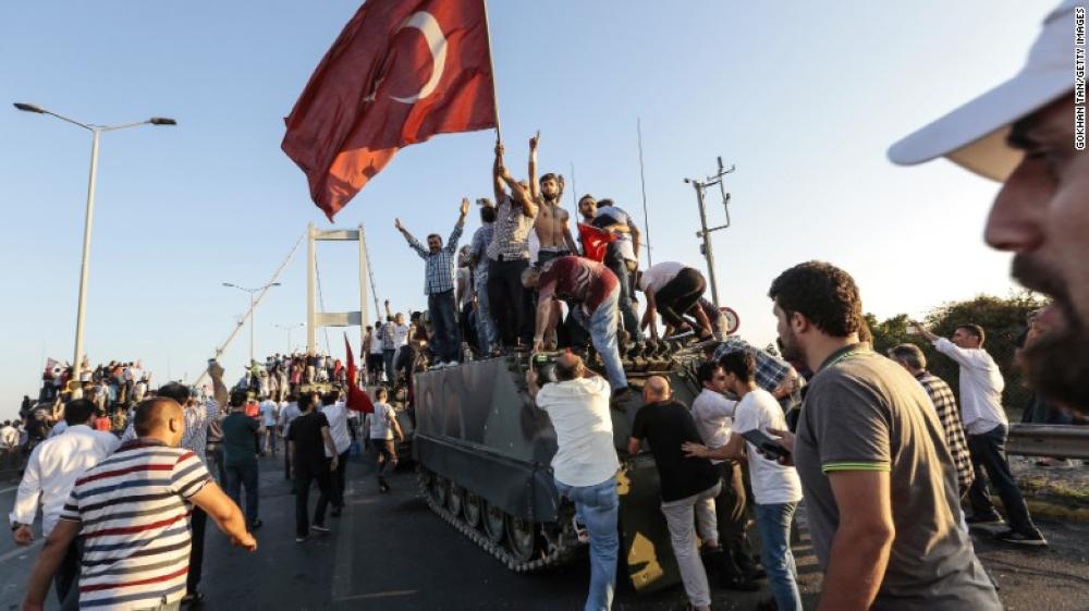 This July 2016 file photo shows Erdogan's supporters capturing a Turkish army vehicle after soldiers surrendered.