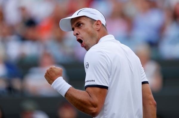 Luxembourg’s Gilles Muller celebrates after winning his fourth round match against Spain’s Rafael Nadal at the WImbledon on Monday. — Reuters