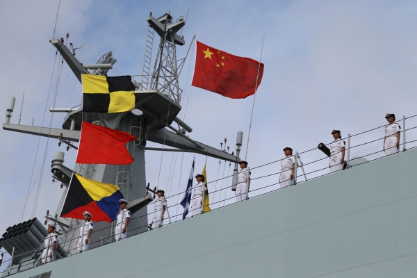 Soldiers of China’s People's Liberation Army (PLA) stand on a ship sailing off from a military port in Zhanjiang, Guangdong province, on Tuesday. — Reuters