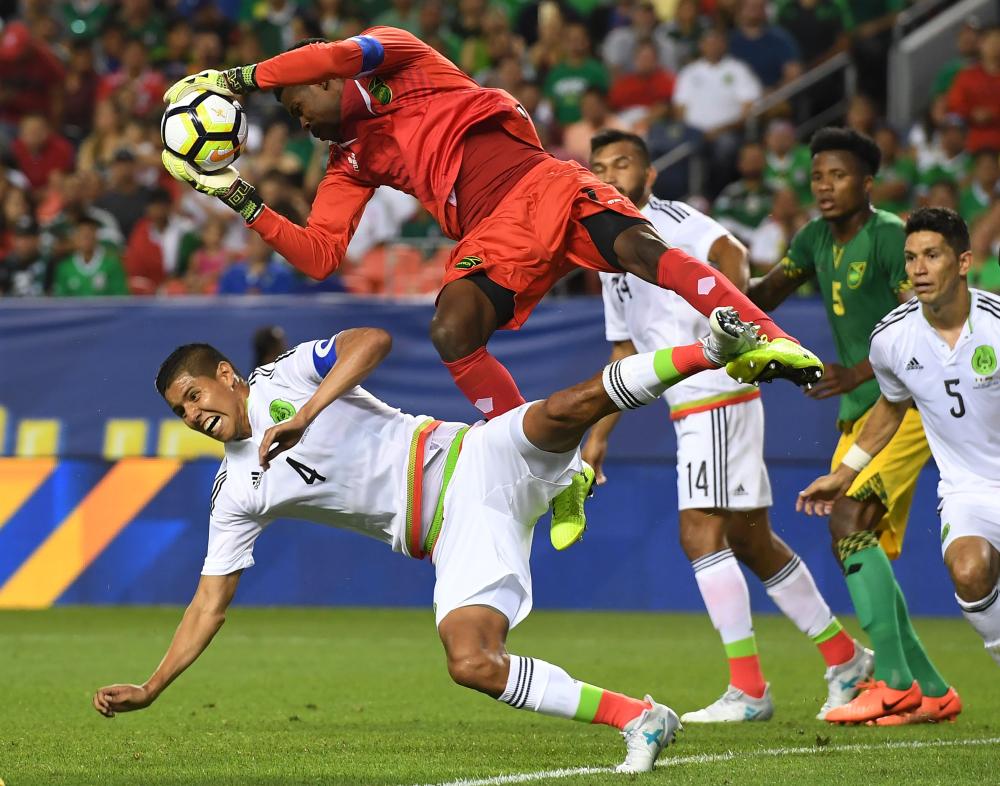 Mexico’s Hugo Ayala (L) is blocked by Jamaica goalkeeper Andre Blake in their Group C game during the 2017 CONCACAF Gold Cup at the Sports Authority Field in Denver, Colorado, Thursday. — AFP 