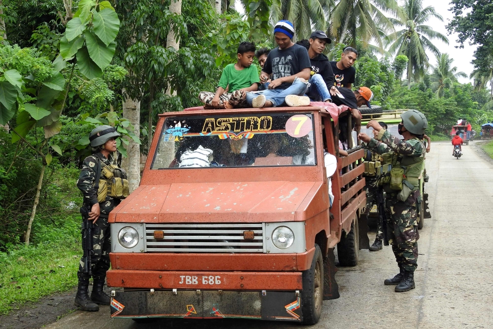 Soldiers inspect a passenger vehicle at a checkpoint in Jolo, Sulu on the southern Philippine Island of Mindanao, on Sunday. — AFP