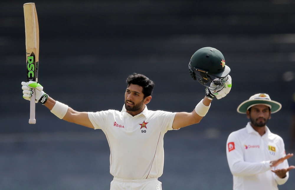 Zimbabwe's Sikandar Raza celebrates scoring a century during the fourth day of the only Test cricket match between Sri Lanka and Zimbabwe in Colombo, Sri Lanka, Monday. — AP