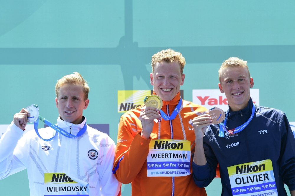 Gold medal winning Ferry Weertman, center, of the Netherlands, silver medal winner  Jordan Wilimovsky, left, of the US and bronze medal winner Marc-Antoine Olivier of France pose on the podium during the medal ceremony of men's open water 10km final of the Swimming World Championships 2017 in Balatonfured, 124 kms southwest of Budapest, Hungary, Tuesday, July 18, 2017.  — AP