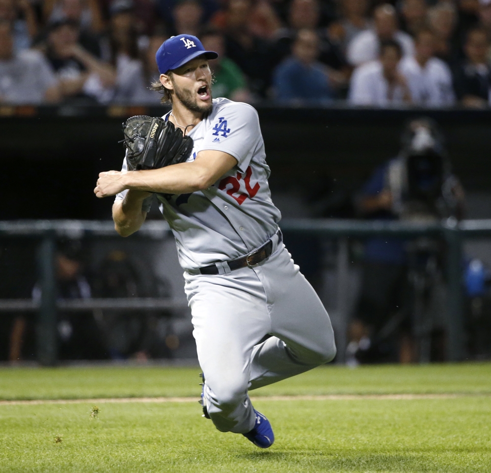Los Angeles Dodgers starting pitcher Clayton Kershaw spins and throws out Chicago White Sox's Adam Engel at first during the seventh inning of a baseball game Tuesday in Chicago. — AP