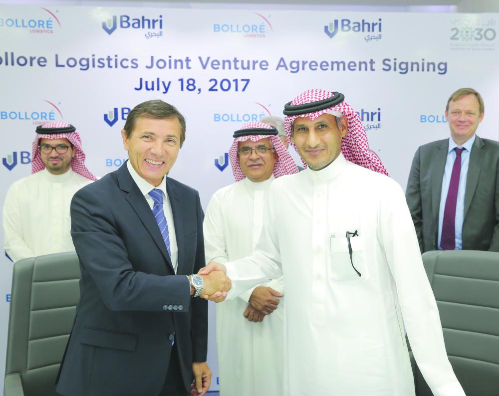 Philippe Lortal (left), CEO of Bolloré Logistics Middle East, South Asia, and Ali Al-Harbi, Acting CEO of Bahri, shake hands after the signing of the joint venture