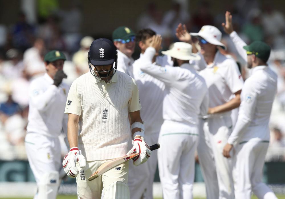 England's Mark Wood walks off the pitch after getting out as the South African team celebrate, during day four of the Second Test cricket match between England and South Africa, at Trent Bridge, Nottingham, England, on Monday. — AP