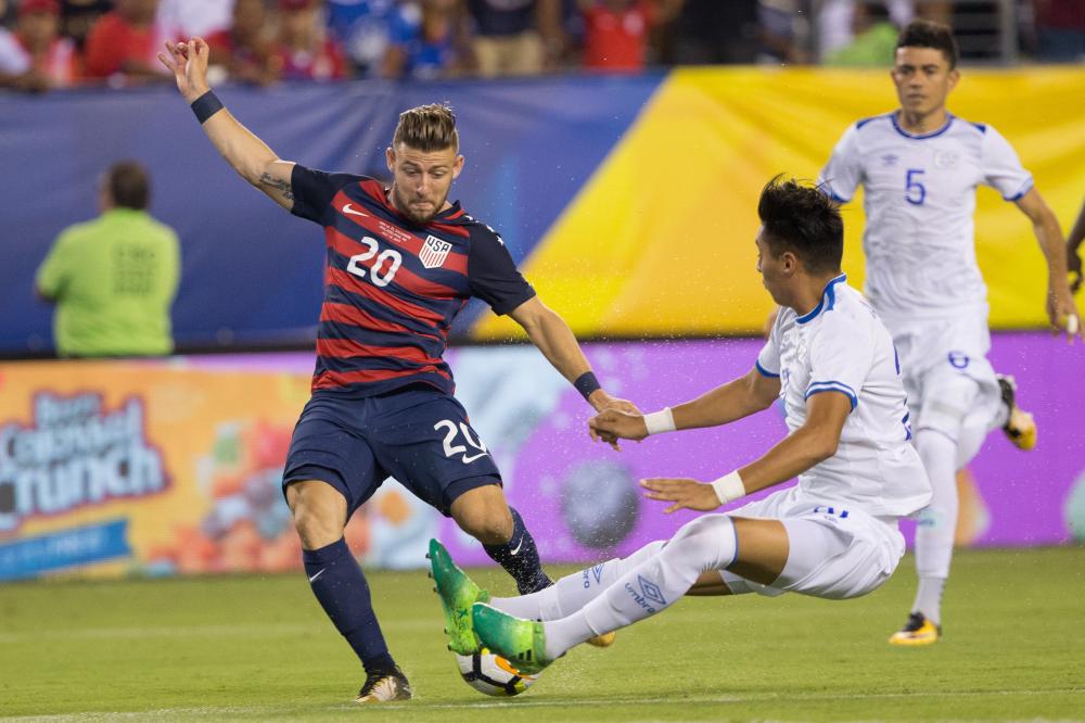 US forward Paul Arriola (L) kicks past a block attempt of El Salvador defender Bryan Tamacas during their Gold Cup match at Lincoln Financial Field in Philadelphia Wednesday. — AFP