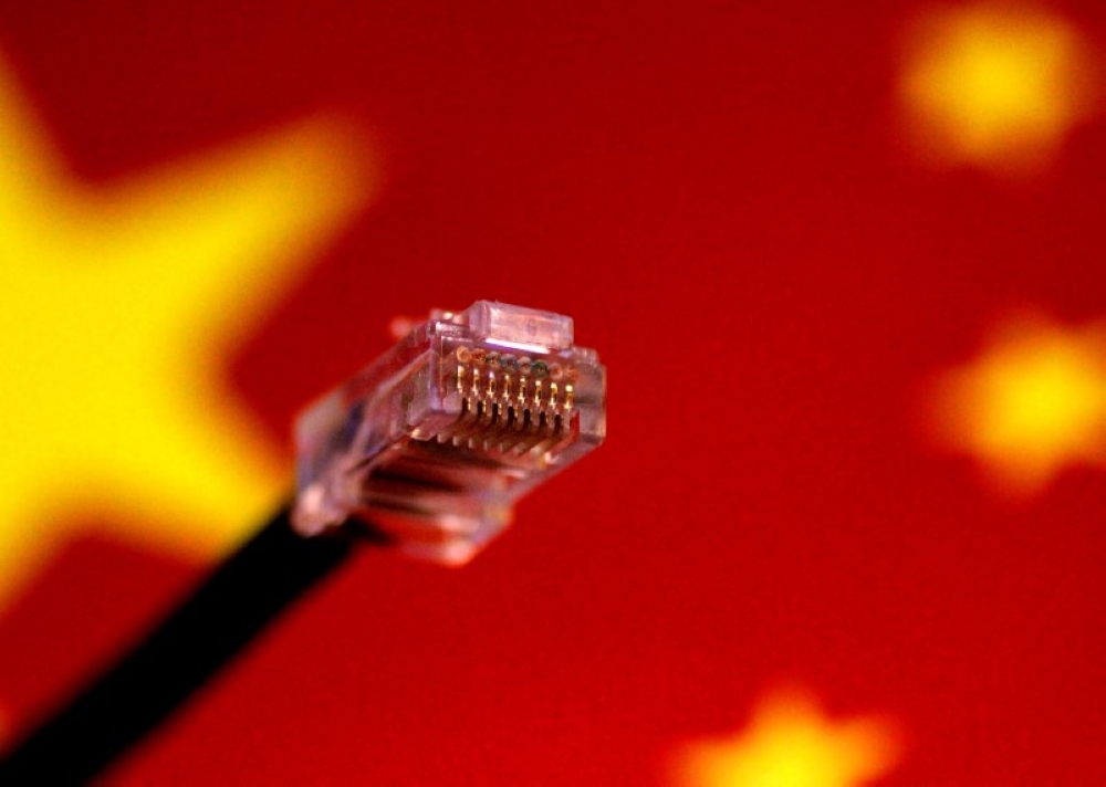 File photo of a computer network cable is seen above a Chinese flag.