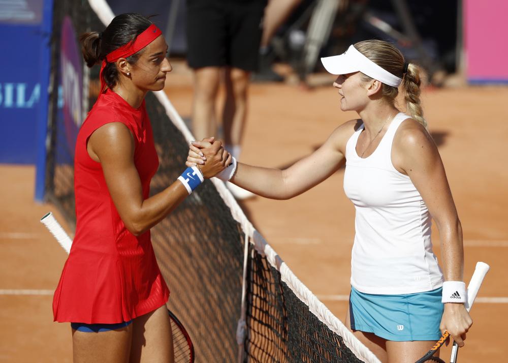 Caroline Garcia (L) of France and Tereza Martincova of the Czech Republic shake hands after their match at the WTA Ladies Championship Tennis Tournament in Gstaad, Switzerland, Thursday. — AP