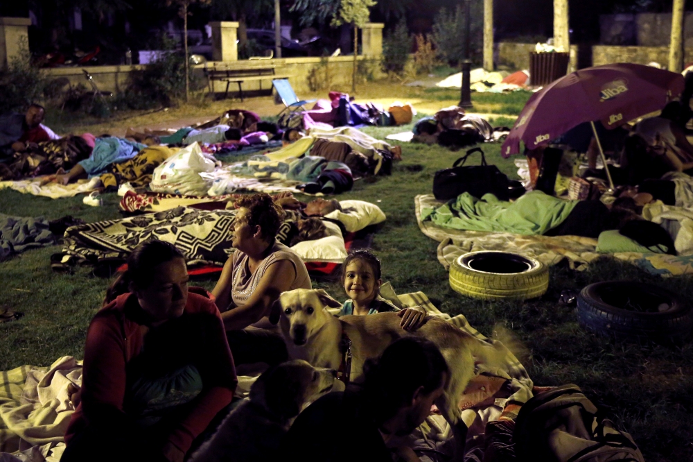 A family prepares to sleep in a park after an earthquake off the island of Kos, Greece, on Saturday. — Reuters 