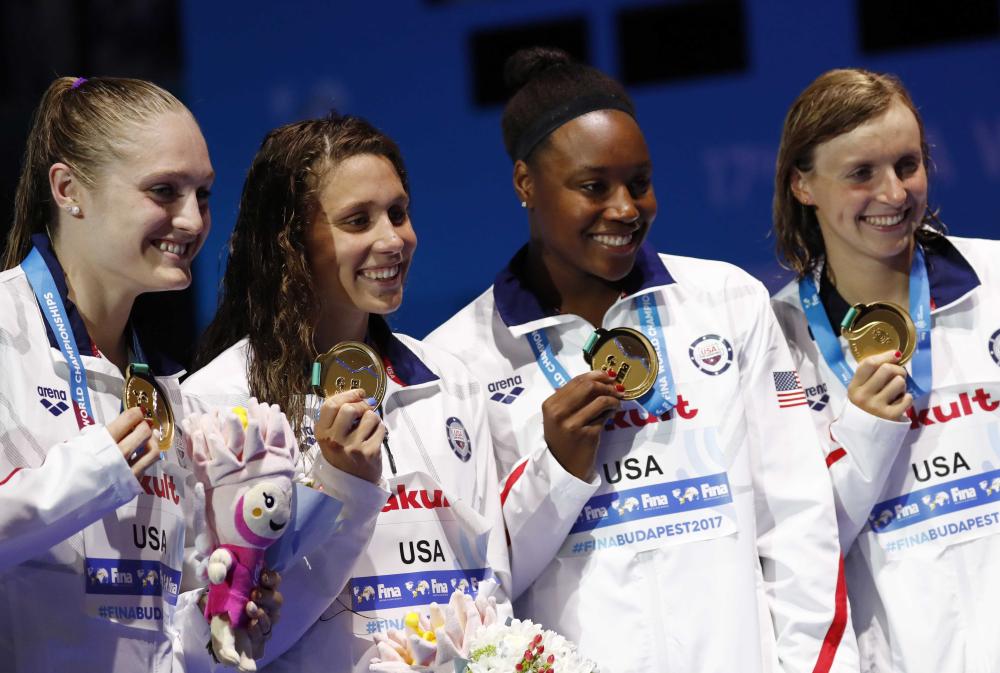 Gold medal winning US swimmers pose with their medals at the 17th FINA World Aquatics Championships in Budapest Sunday. — Reuters