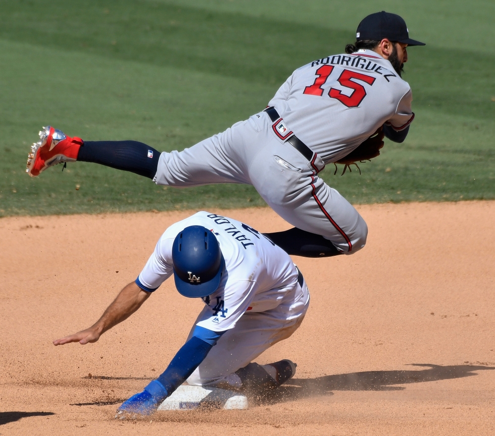 Los Angeles Dodgers left fielder Chris Taylor (3) upends Atlanta Braves first baseman Sean Rodriguez (15) on a double play ball in the 10th inning at Dodger Stadium. — Reuters