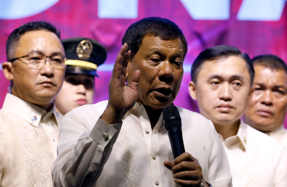 Philippine President Rodrigo Duterte speaks to protesters after he delivered his State of the Nation address at the Congress in Quezon city, Metro Manila, on Monday. — Reuters