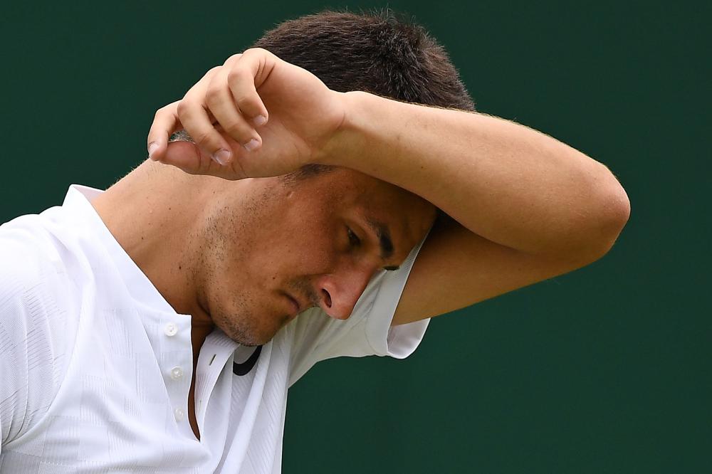 A file photo shows Australia's Bernard Tomic reacting against Germany's Mischa Zverev during their men's singles first round match on the second day at 2017 Wimbledon Championships in London. Apathetic Australian star Bernard Tomic has admitted he is playing tennis just for the money and says he has no love for the game that has earned him millions. — AFP