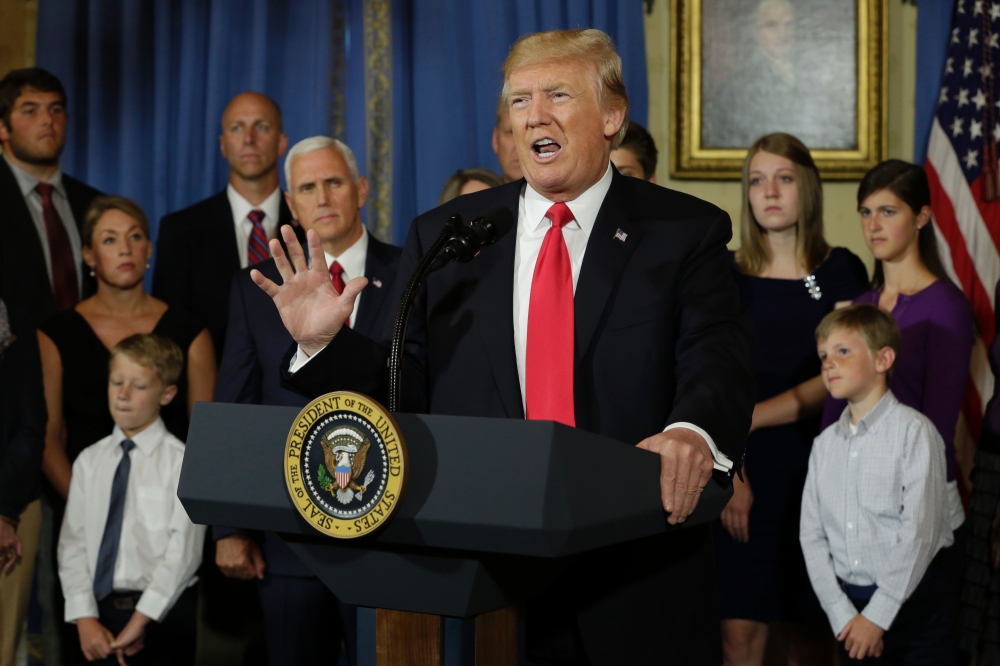 US President Donald Trump delivers s statement on health care in front of alleged “victims of Obamacare” at the White House in Washington on Monday. — AFP