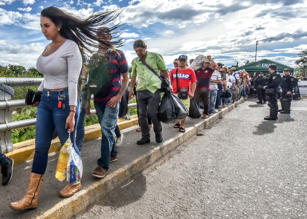 Venezuelan citizens cross the Simon Bolivar international bridge from San Antonio del Tachira, Venezuela to Cucuta, Norte de Santander Department, Colombia, on Tuesday. — AFP