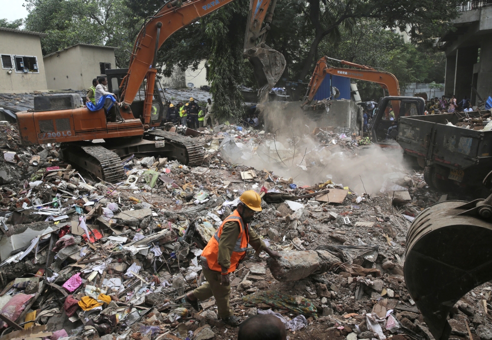 Rescuers look for survivors on the second day after a five-story building collapsed in the Ghatkopar area of Mumbai, India, on Wednesday. — AP
