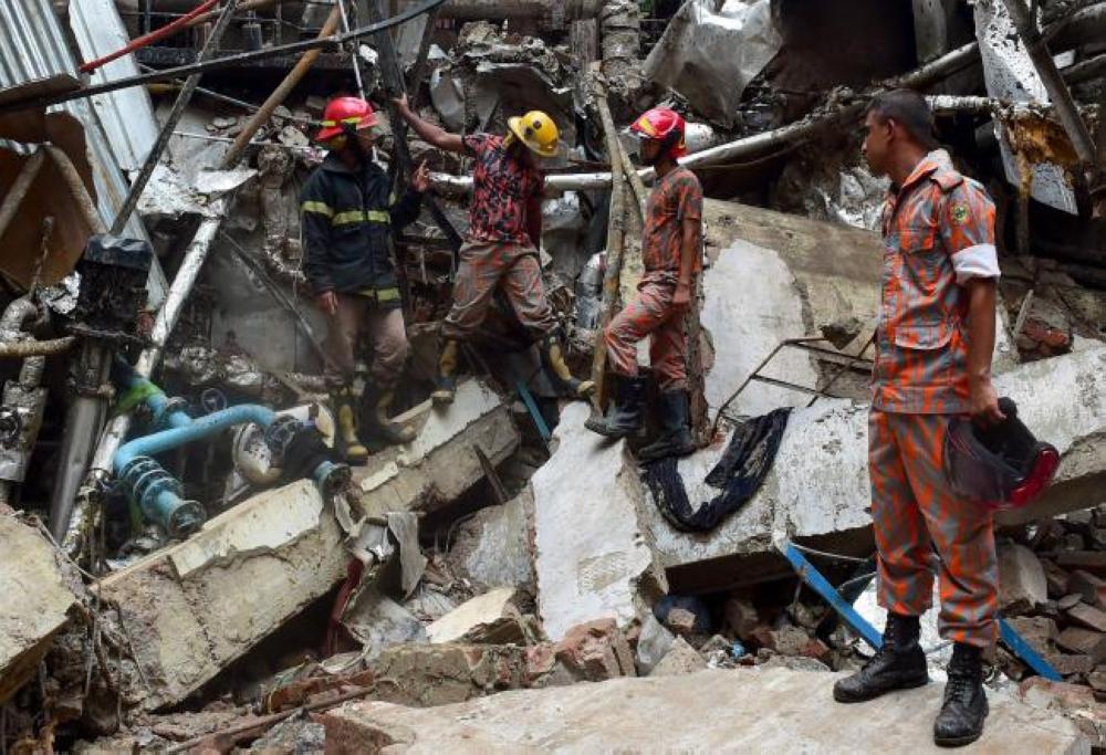 Bangladeshi firefighters take part in a search and rescue operation at a destroyed garment factory in Gazipur on July 4, 2017, after a boiler explosion at the complex on the outskirts of Dhaka. — AFP
