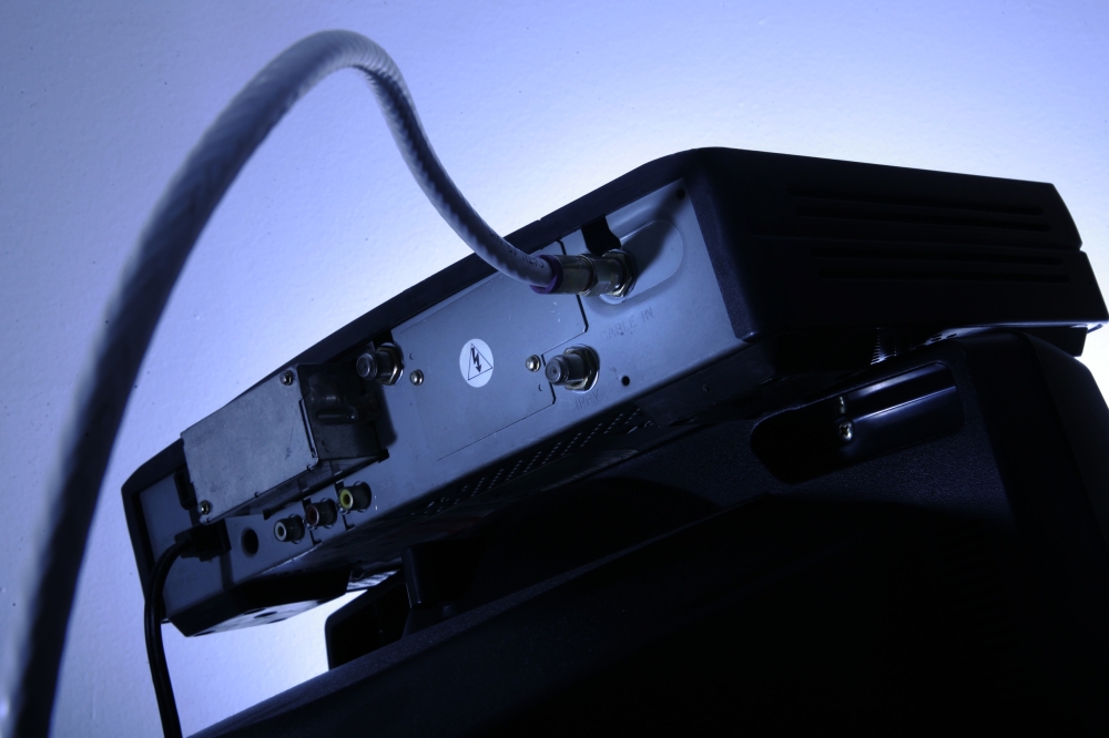 This file photo shows a cable box on top of a television set in Philadelphia. Not that long ago, the clunky cable box looked like it was on its way out. The federal government was pressuring cable companies to open up their near-monopoly on boxes to more competition, and industry leader Comcast promised apps that could render some boxes obsolete. But today, the vast majority of customers still need to rent a box to get full service from cable providers, and those box-replacing apps remain elusive. — AP