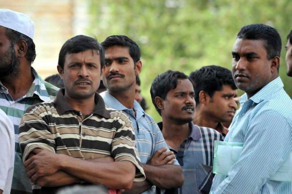 File photo shows expats waiting to finalize procedures to either transfer their residency to a new company or stamp exit to leave the country. 
