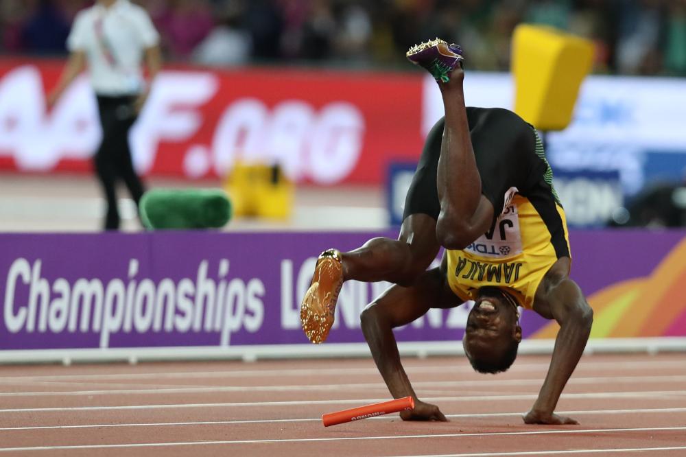 Usain Bolt lies on the track after injuring himself at the London Stadium Saturday. — AFP