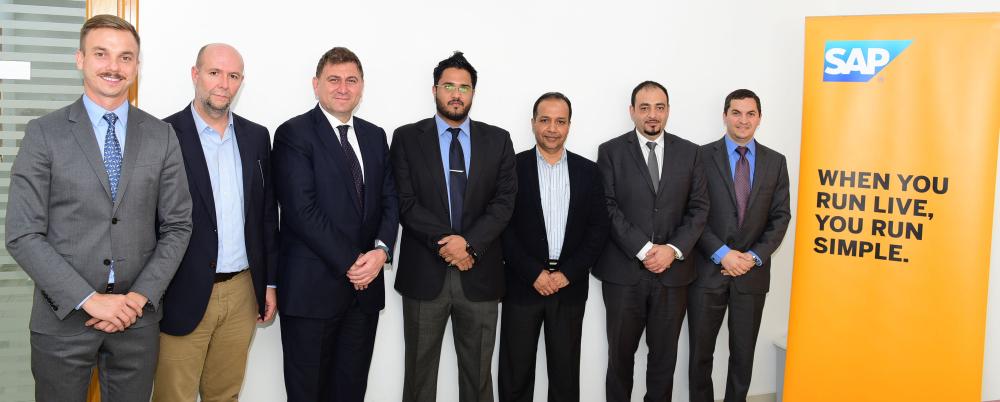 V.T. Vinodan, Managing Director, Mars Hypermarket Oman and UAE, with Tayfun Topkoc, Managing Director, SAP Oman and UAE in a group photo session with other executives of both companies

