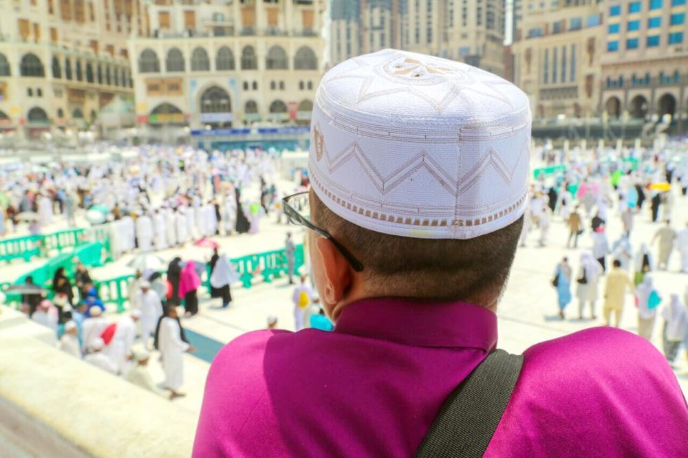 A security man helps a blind an aged pilgrim in Makkah, Monday. — Okaz photo