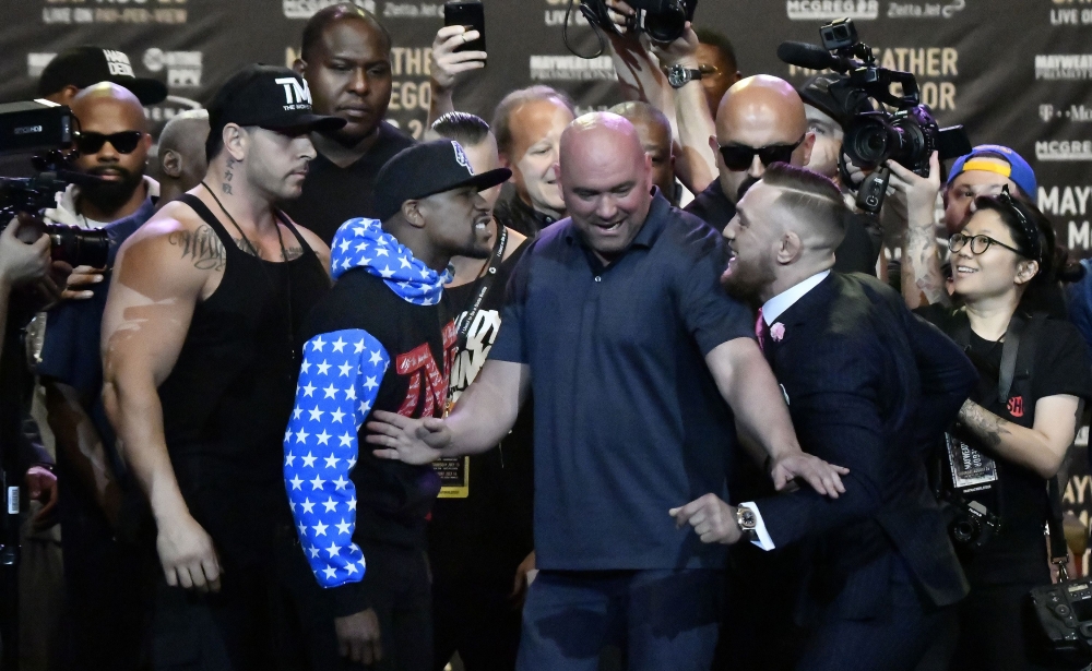This file photo shows Floyd Mayweather Jr. (L) as he faces off for the first time with UFC fighter Conor McGregor during a press call at the Staples Center in  Los Angeles, California. — AFP