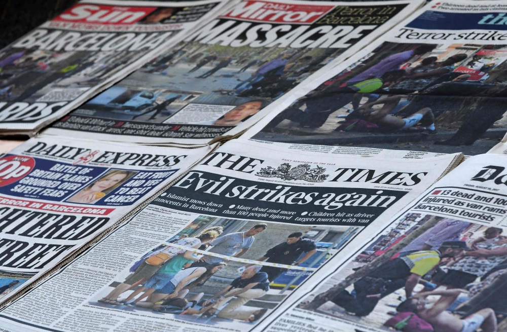 A picture taken on Friday shows front pages of British national newspapers, with stories dedicated to the Barcelona attack, one day after a van ploughed into the crowd, killing 13 persons and injuring over 100 on the Rambla boulevard in Barcelona. Drivers have plowed on Thursday into pedestrians in two quick-succession, separate attacks in Barcelona and another popular Spanish seaside city, leaving 13 people dead and injuring more than 100 others. — AFP