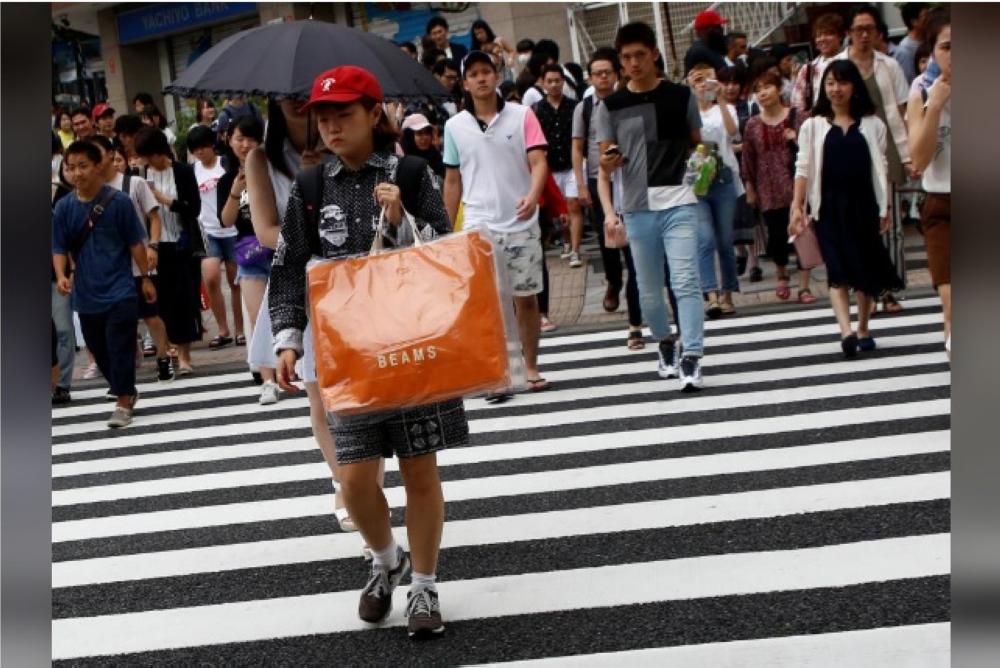Pedestrians are pictured at a shopping district in Tokyo, Japan. — Reuters