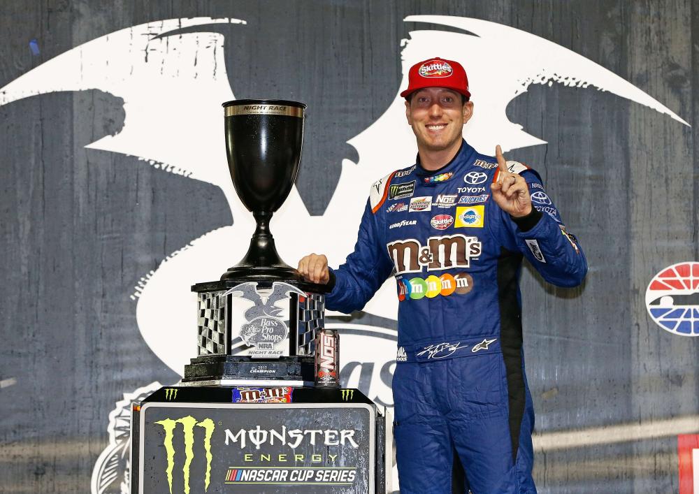 
Kyle Busch, driver of the #18 M&M’s Caramel Toyota, poses with the trophy after winning the Monster Energy NASCAR Cup Series Bass Pro Shops NRA Night Race at Bristol Motor Speedway Saturday. — AFP