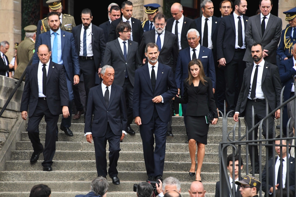 Spain’s King Felipe VI, center, Queen Letizia, right, and Portugal’s President Marcelo Rebelo de Sousa, left, leave after a mass on Sunday to commemorate victims of two devastating terror attacks in Barcelona and Cambrils, at the Sagrada Familia church in Barcelona.  — AFP