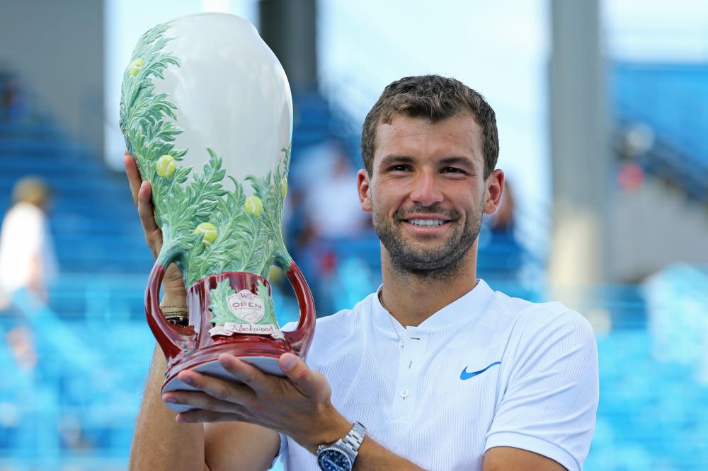 Grigor Dimitrov of Bulgaria holds the Rookwood Cup after defeating Nick Kyrgios of Australia in the final of the Western and Southern Open at the Lindner Family Tennis Center in Mason, Ohio, Sunday. — Reuters