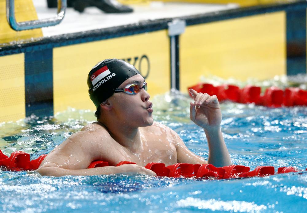 Joseph Schooling of Singapore reacts after the 50m butterfly final of the 29th SEA Games at the National Aquatics Centre in Kuala Lumpur Monday. — Reuters