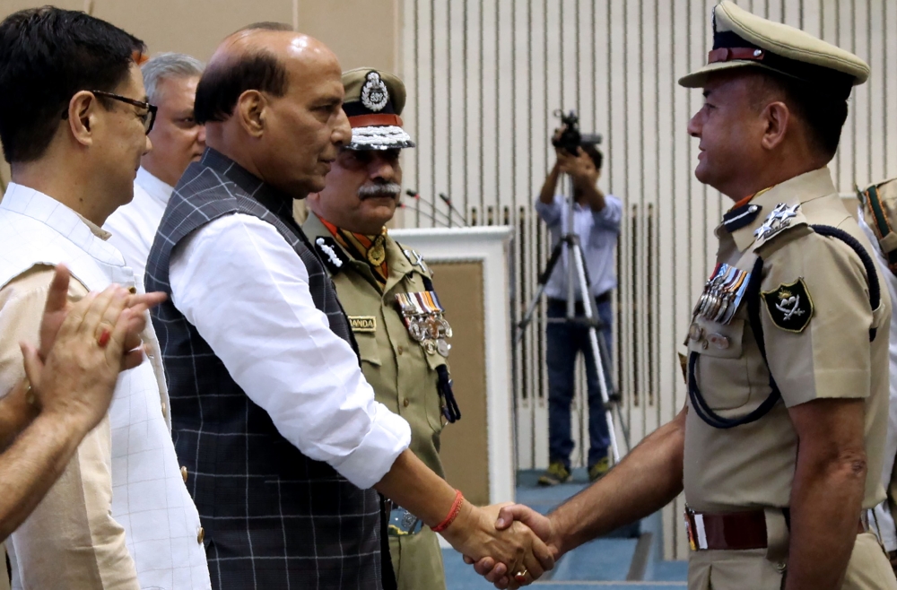 This handout photograph released by the Indo Tibetan Border Pratrol (ITBP) shows Indian Home Affairs minister Rajnath Singh, second left, greeting newly promoted officials of the Indo-Tibetan Border Patrol (ITBP) during an event in New Delhi on Monday. — AFP 