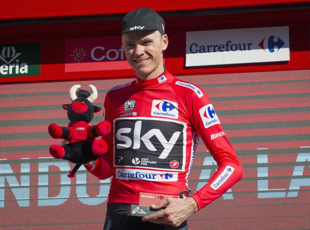 Sky’s British cyclist Chris Froome poses on the podium with the leader’s red jersey at the end of the 3rd stage of the 72nd edition of “La Vuelta” Tour of Spain cycling race on August 21, 2017 in Andorra la Vella. — AFP 
