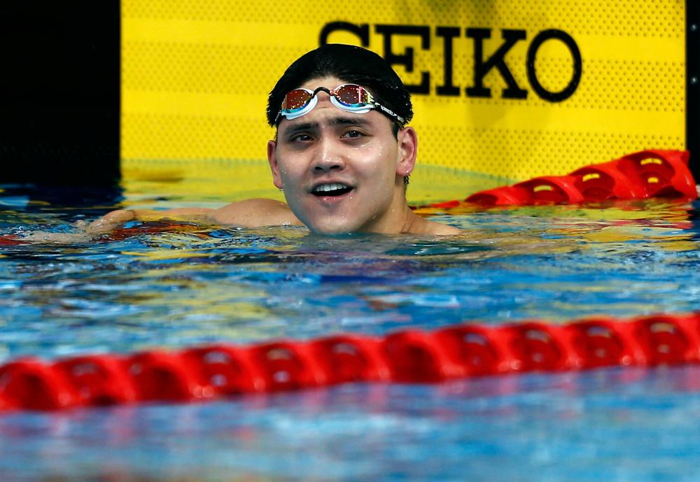 Joseph Schooling of Singapore reacts after winning 100 meters butterfly at the Southeast Asian (SEA) Games in Kuala Lumpur  Wednesday. — Reuters