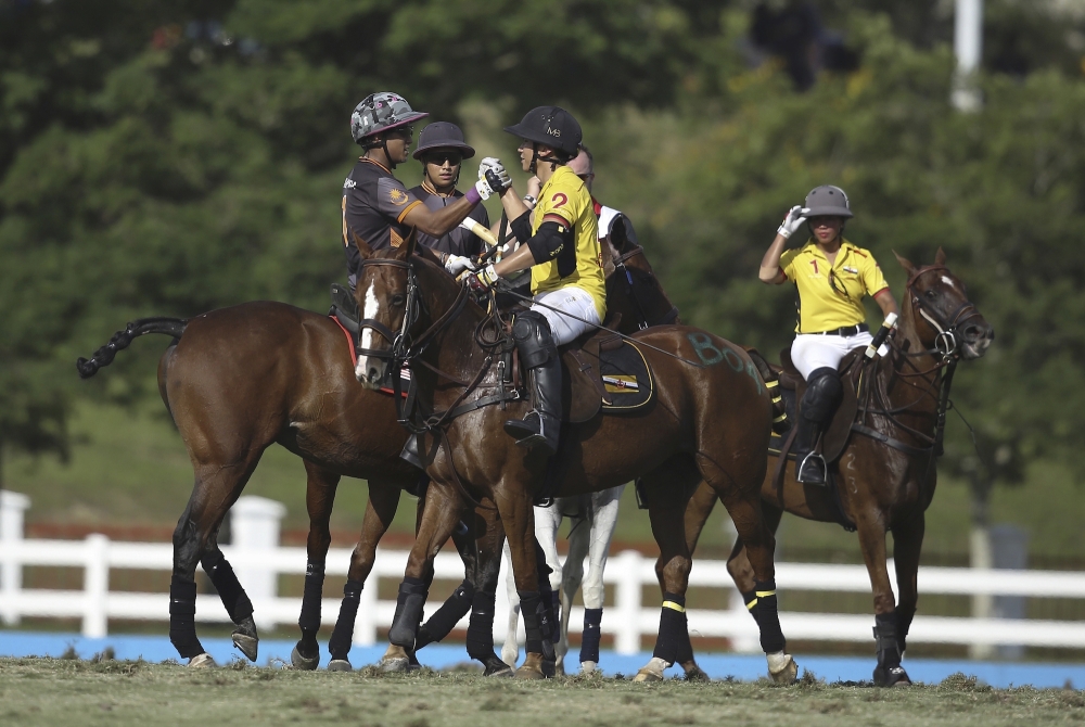 In this photo handout by SEA Games official and taken on Tuesday, Malaysian Youth and Sports Minister Khairy Jamaluddin, left, shakes hand with Brunei's Prince Abdul Mateen, right, after the equestrian polo games during the South East Asian Games in Putrajaya, Malaysia. Malaysia’s polo team scored a second victory in the Games before facing an unusual challenge from a sultan. The polo players, including Youth and Sports Minister Khairy Jamaluddin, have been challenged to a match by the crown prince of Johor state. — AP