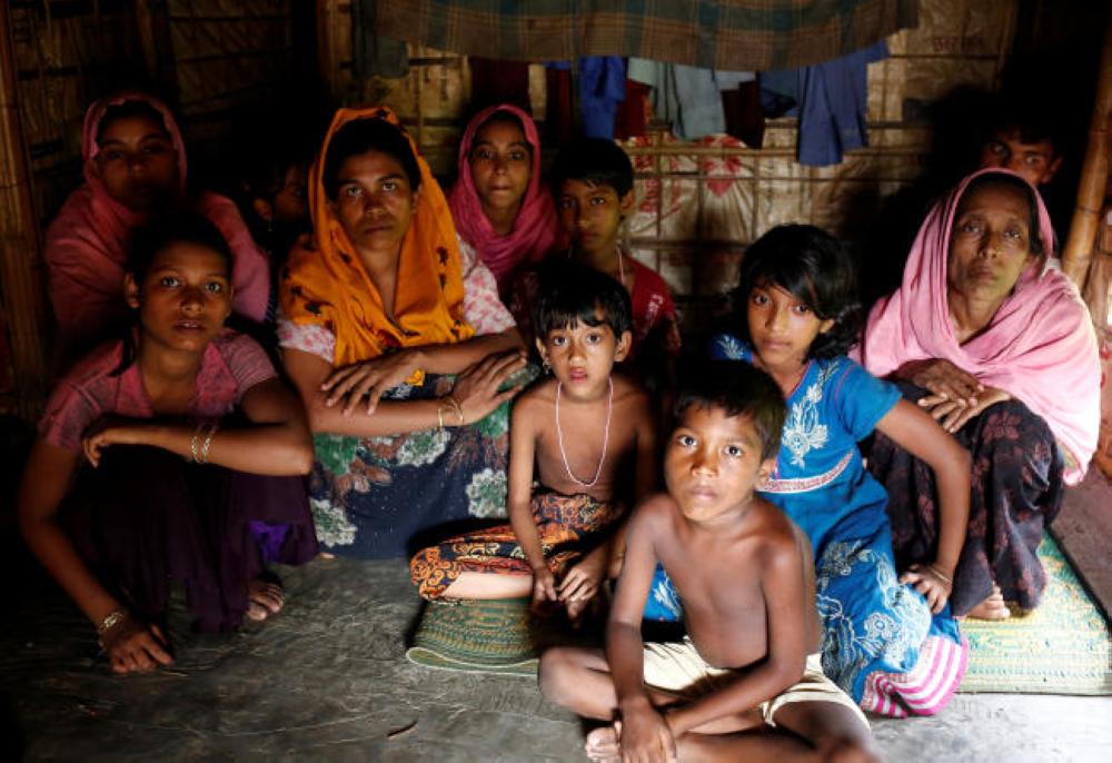 A group of Rohingya refugees takes shelter at the Kutuupalang makeshift refugee camp, after crossing the Myanmar-Bangladesh border today in Cox’s Bazar, Bangladesh, on Saturday. — Reuters
