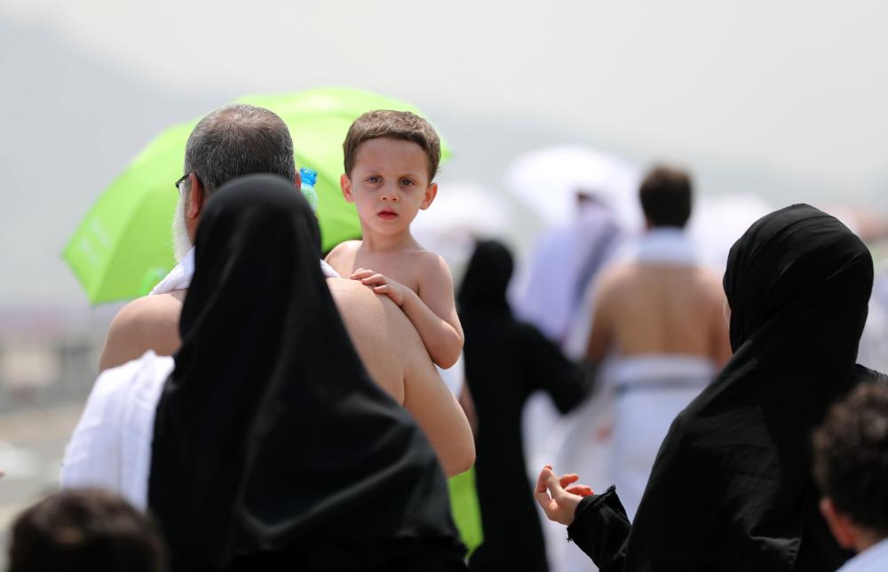 Muslim pilgrims walk near Mount Arafat, also known as Jabal Al-Rahma (Mount of Mercy), on Arafat Day which is the climax of the Haj pilgrimage early on Thursday. —  AFP