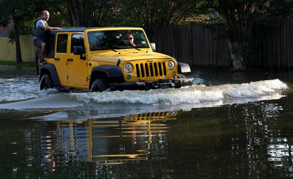 A family in a car returns to their home for the first time since Harvey floodwaters arrived in north western Houston, Texas on August 31, 2017.  — Reuters

